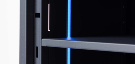 Close-up of a shelf inside what is a slim bright blue LED light.
