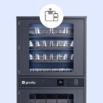 Gray industrial vending machine branded 'Gravity' with multiple transparent compartments, featuring icons for card access and smart device functionality, highlighted by an icon above indicating weight-sensing feature.