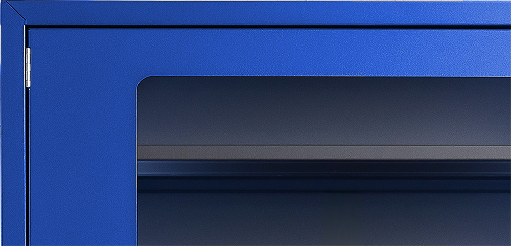 Close-up of the corner of the cending machine which panel is bright blue and in front is a darkened glass.