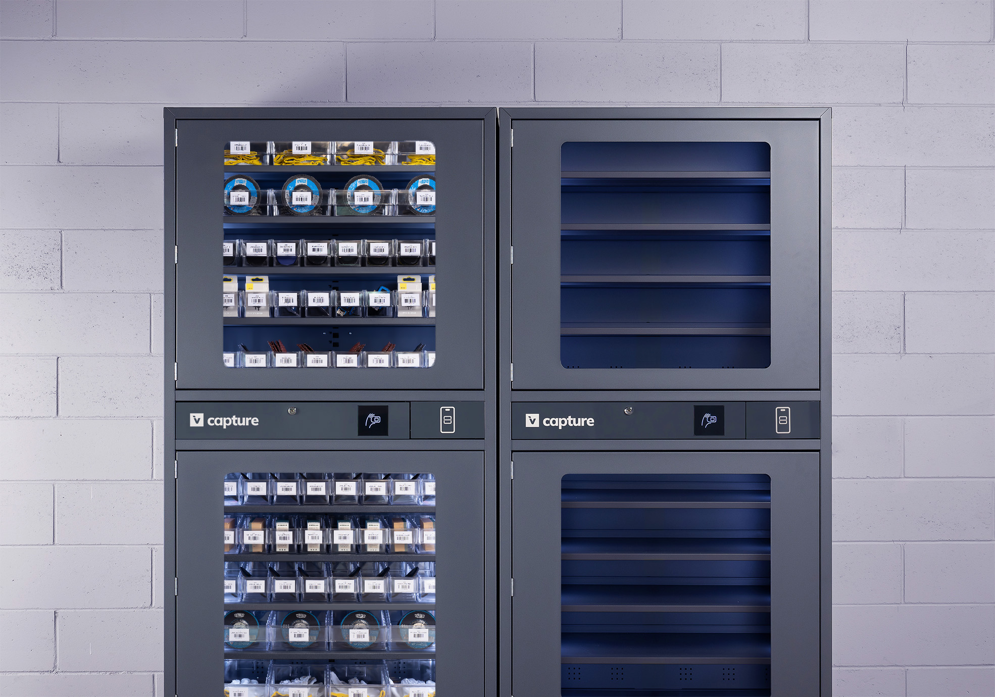 Two Invendor Capture cabinets next to each other. One is filled, second one is empty. The cabinet stands in front of a brick wall.